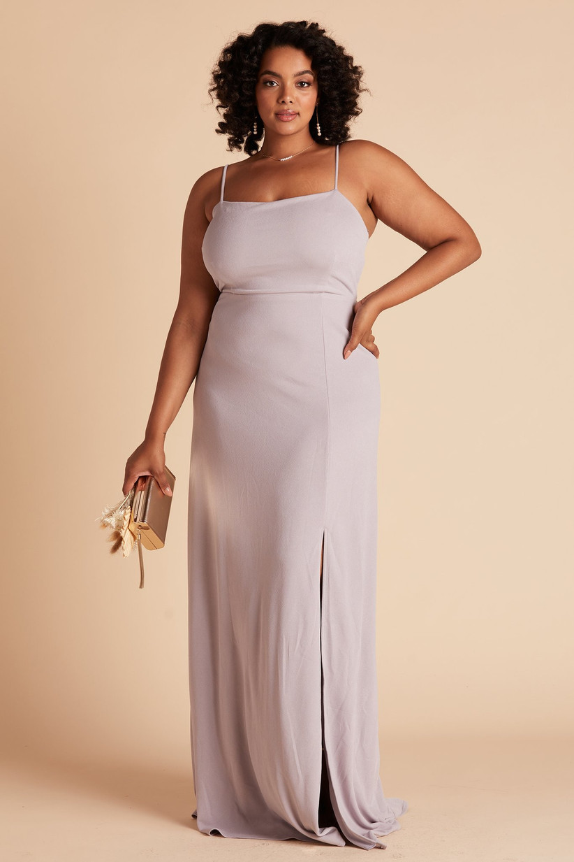 Model wearing minimalist pastel purple bridesmaid dress with subtle leg slit and simple straight neckline