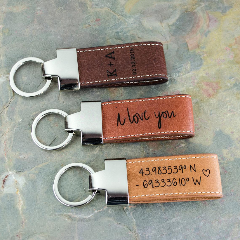 Three leather keychains in varying shades of brown with personalization
