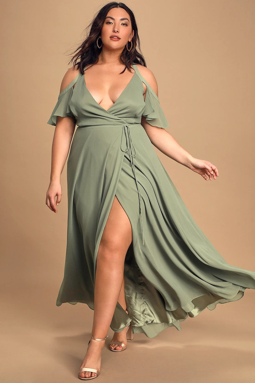 Model wearing cold-shoulder pastel green bridesmaid dress with deep V neckline and leg slit