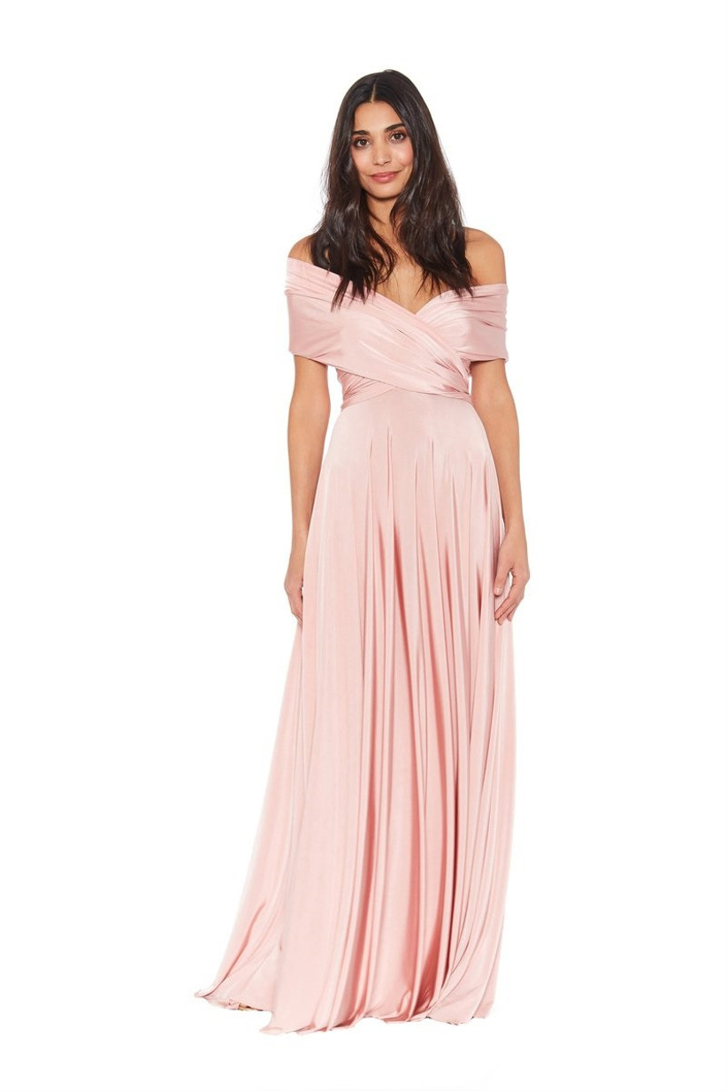 Model wearing convertible pastel pink bridesmaid dress with off-the-shoulder wrap