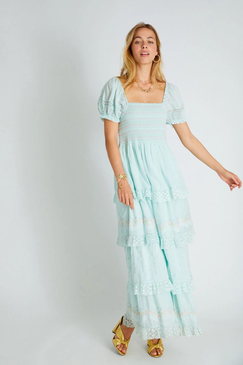 Model wearing boho pastel blue frock with lace tiers and puffed sleeves