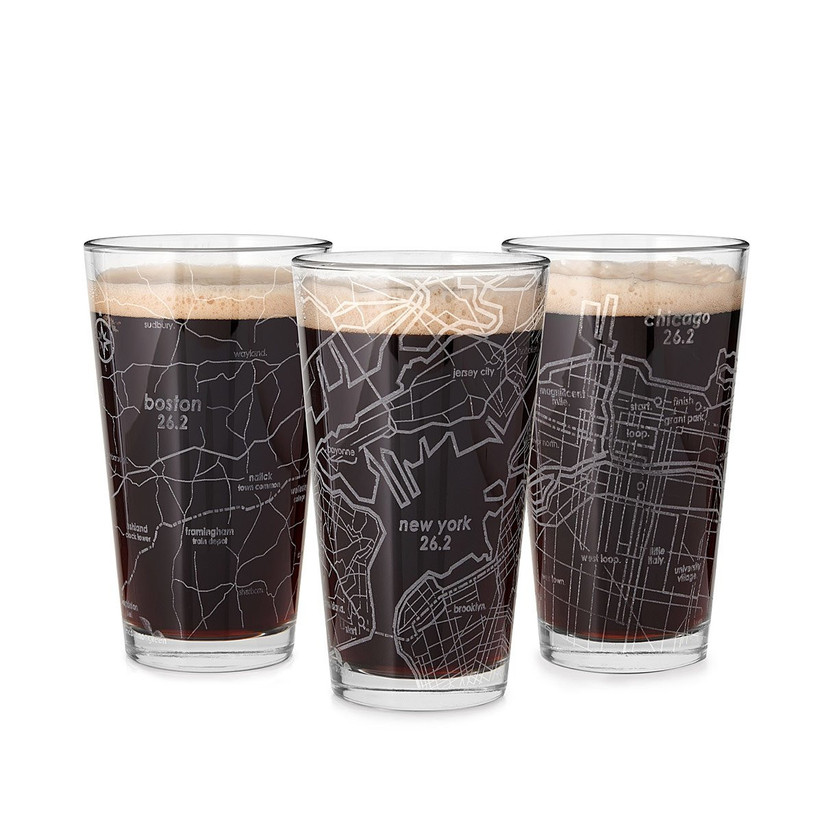 Three pint glasses etched with map of Boston, New York, and Chicago marathon routes