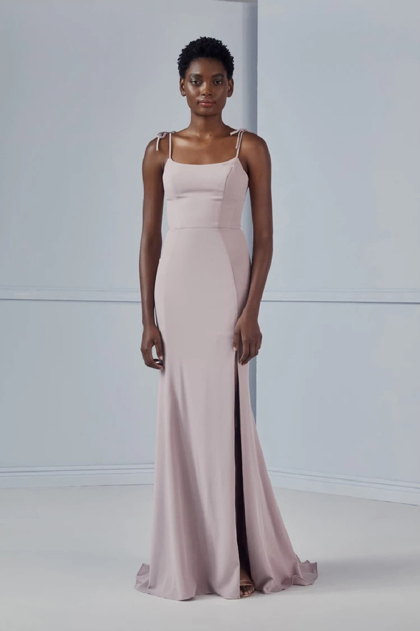 Model wearing minimalist pastel purple bridesmaid dress with tie-at-the shoulder straps