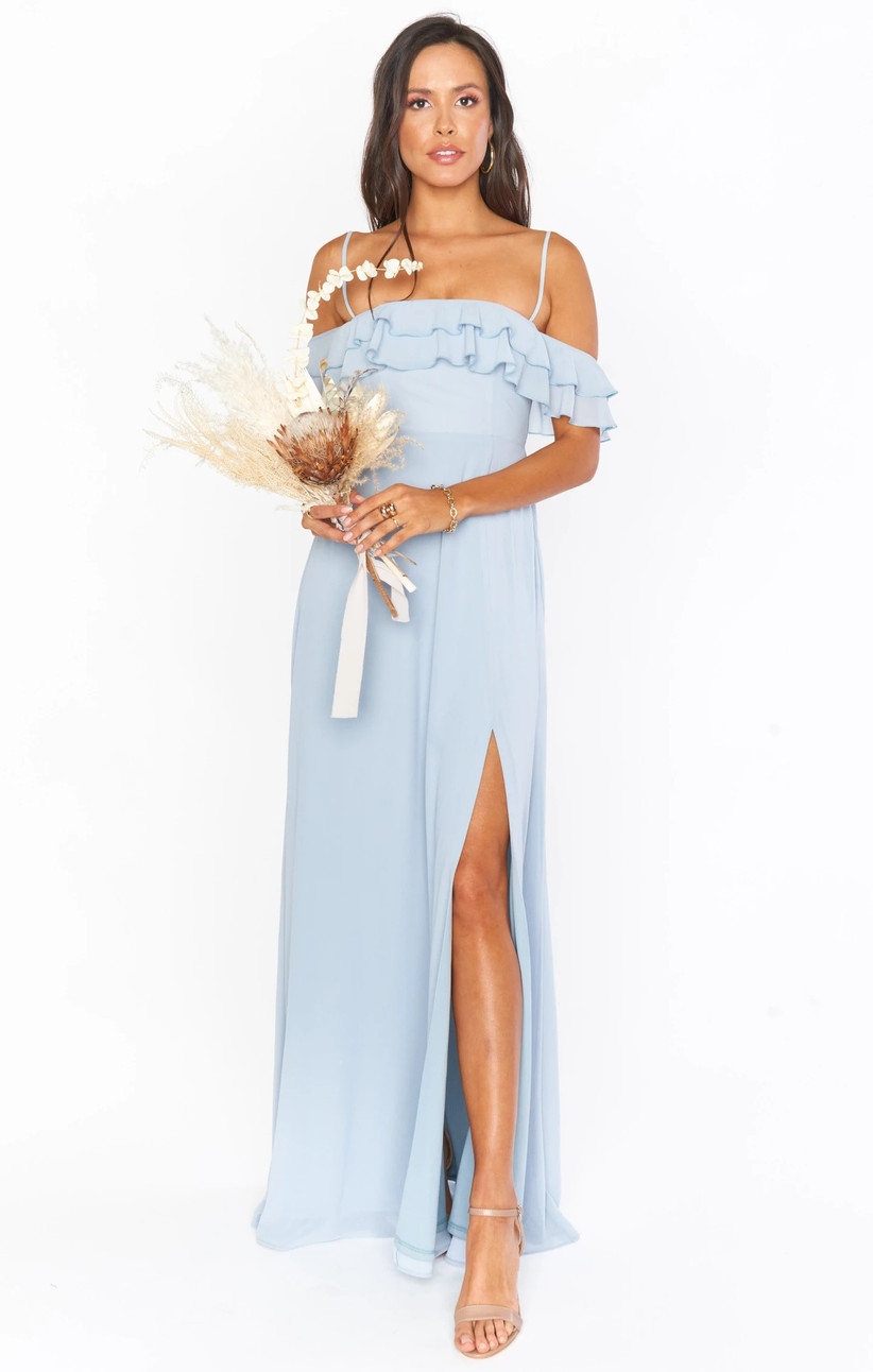 Model wearing spaghetti strap off-the-shoulder ruffle pastel blue bridesmaid dress