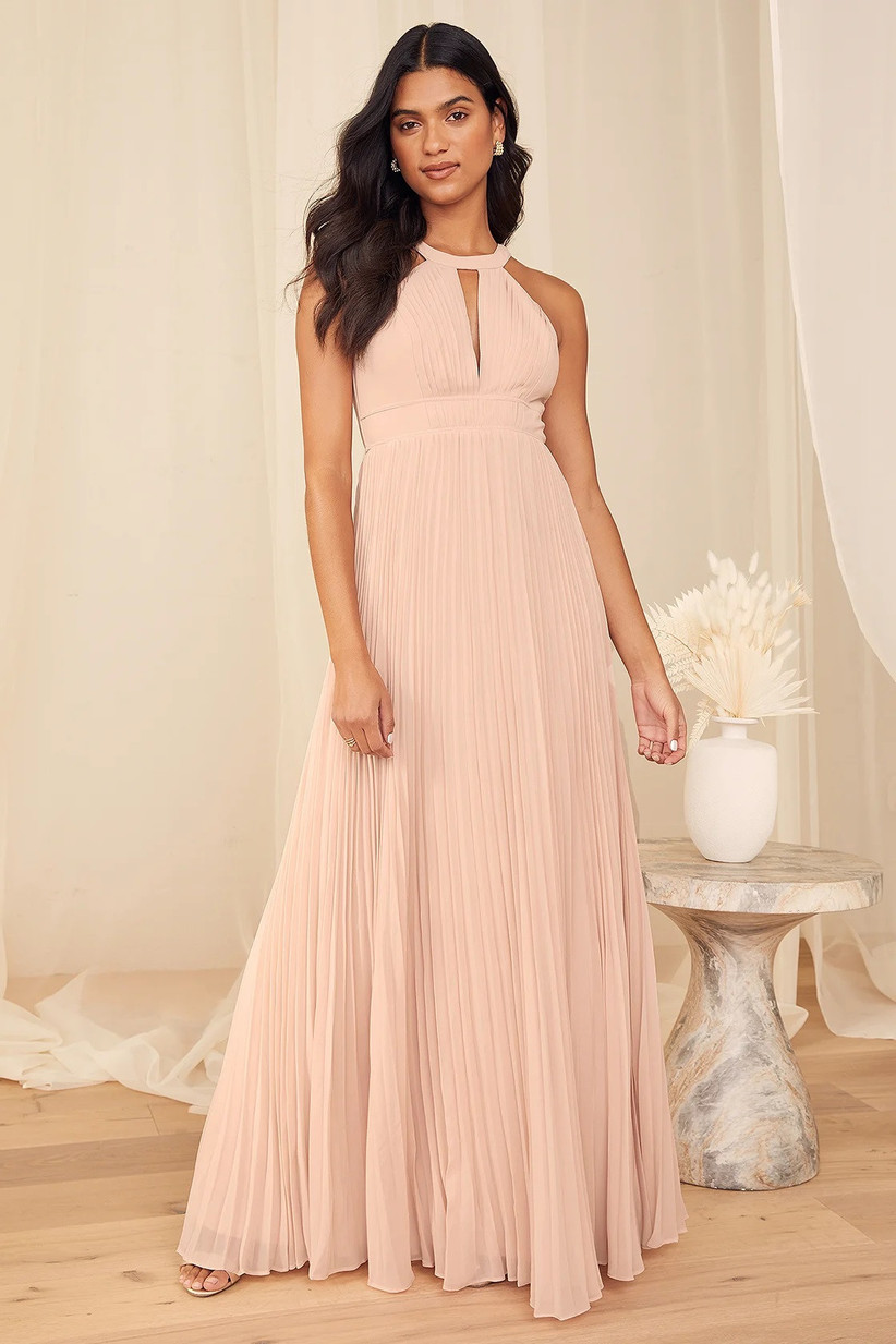 Model wearing pleated high neck pink pastel maxi with keyhole detail