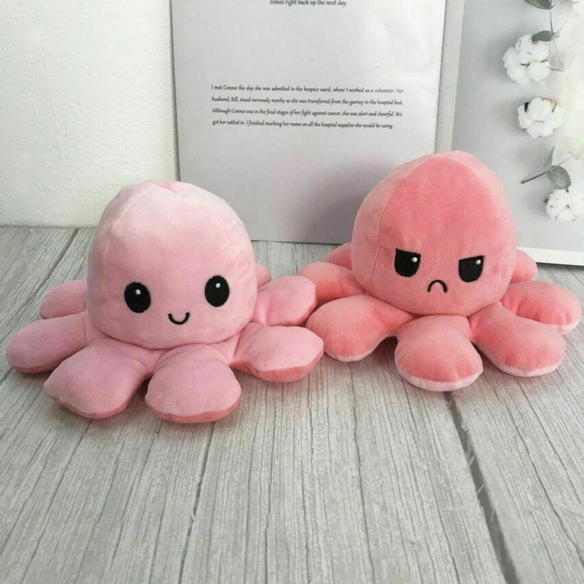 Two pink octopus plushies showing happy and angry faces