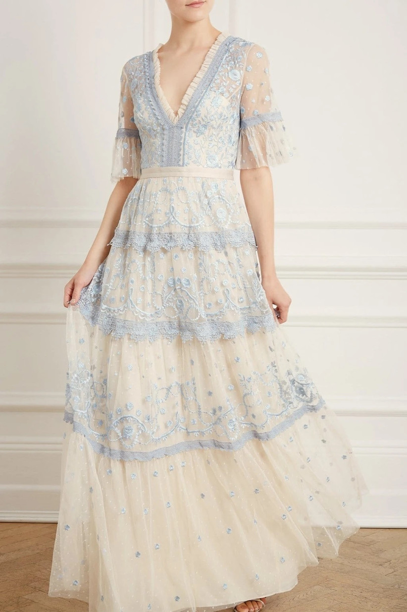 Model wearing vintage style embroidered white and pastel blue dress