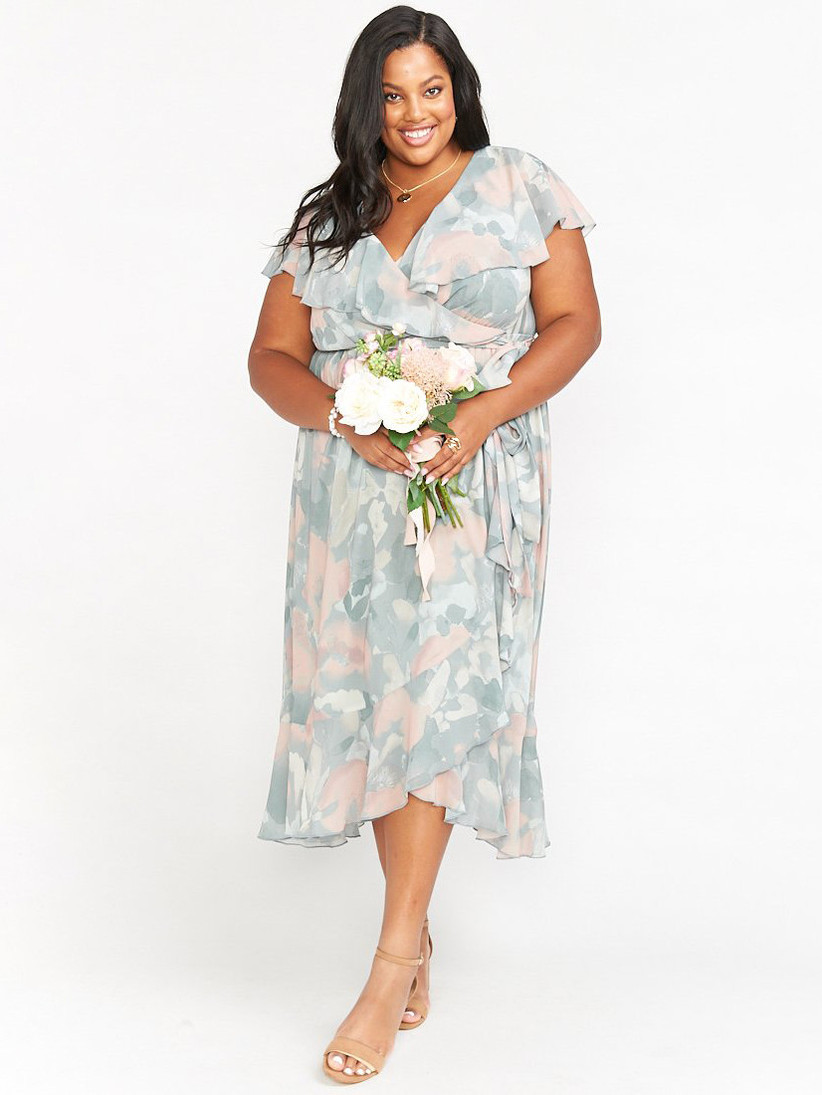 Model wearing floral midi dress with various pastel hues