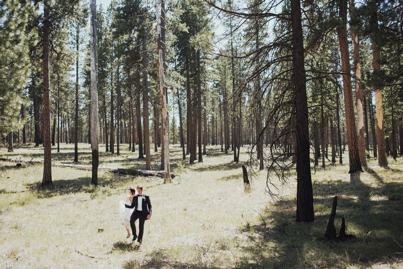 wedding couple walking in the woods