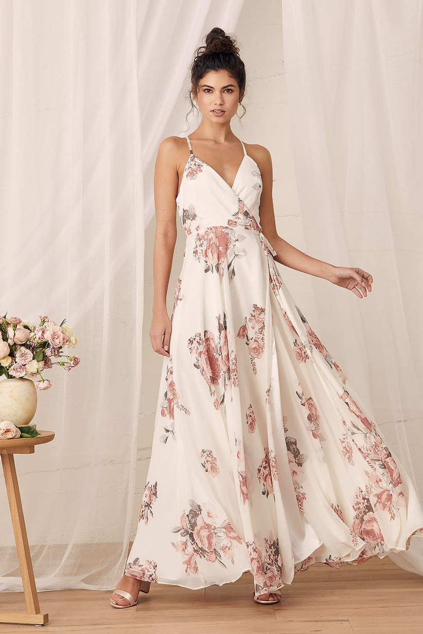 Model wearing cream maxi dress with pink florals