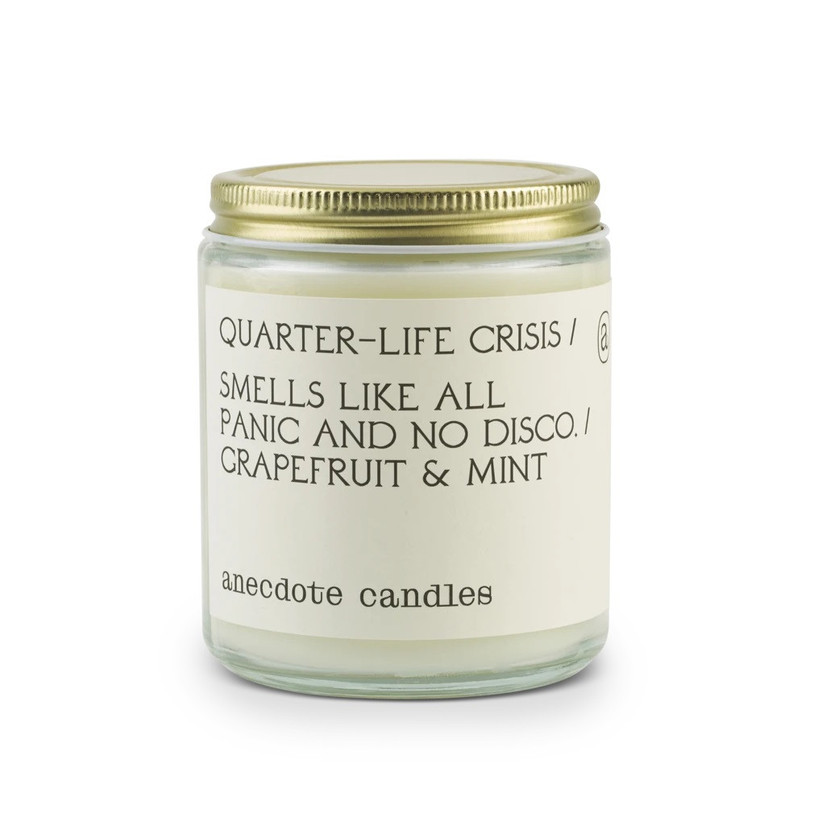 Cute tinned candle with label that reads Quarter-Life Crisis, smells like all panic and no disco
