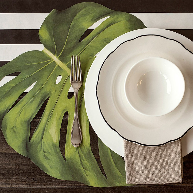 Sophisticated tropical place setting with monstera leaf place mat