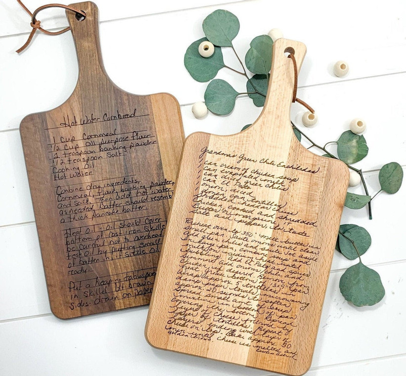 Dark and light wood cutting and serving boards engraved with recipes in different handwriting