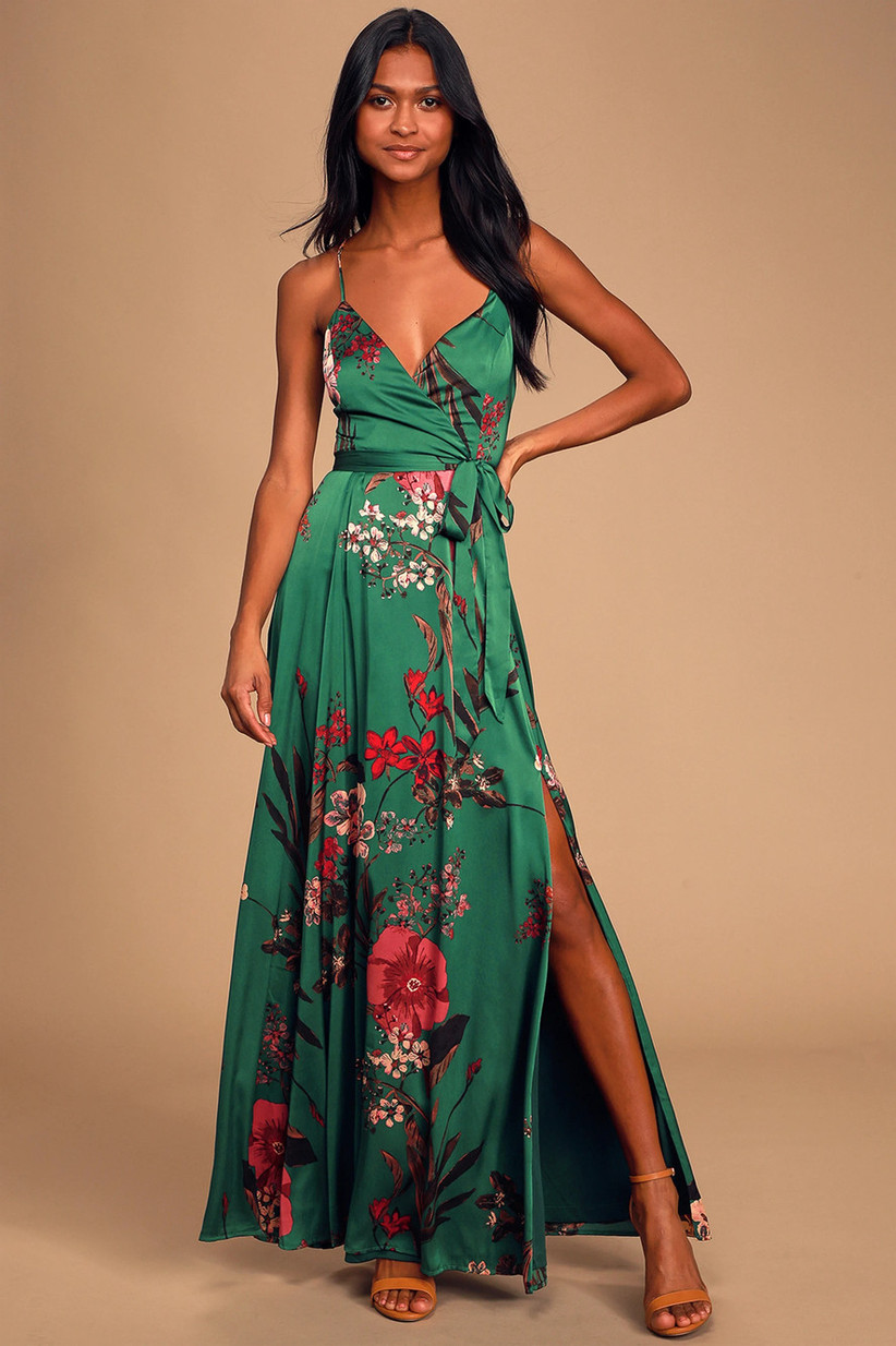Model wearing emerald green maxi with bright red and pink floral pattern