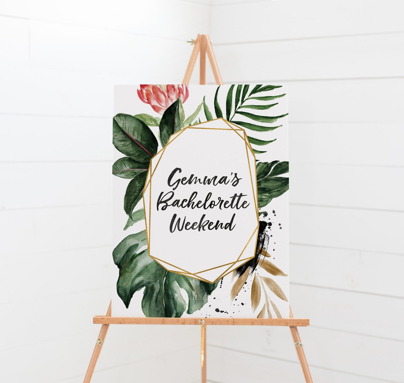 Elegant tropical-theme bachelorette weekend welcome sign on wooden stand