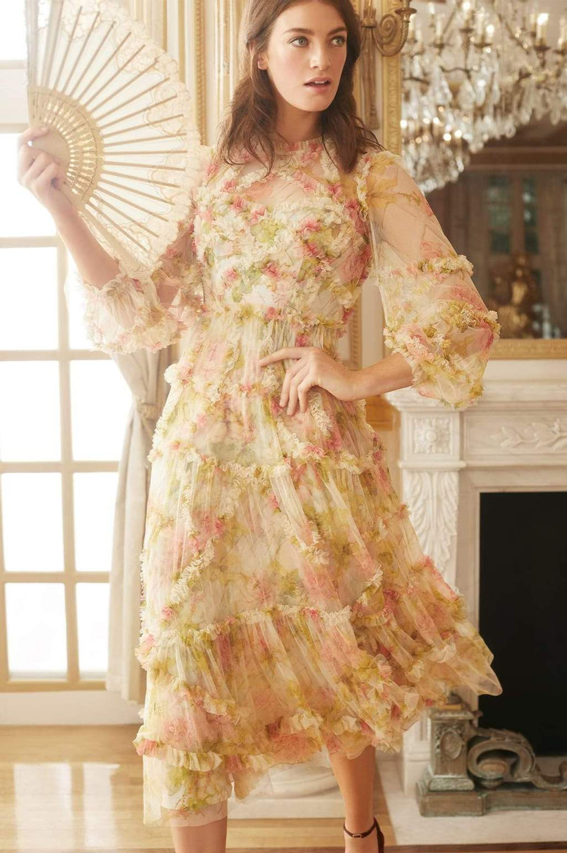 Model wearing vintage ruffled midi with pink and green florals, high neckline, and three-quarter-length sleeves