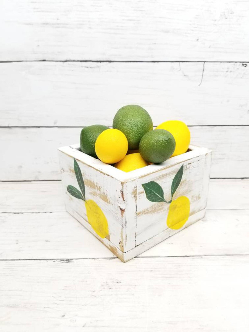 Rustic bridal shower centerpiece planter painted with lemons and filled with lemons and limes