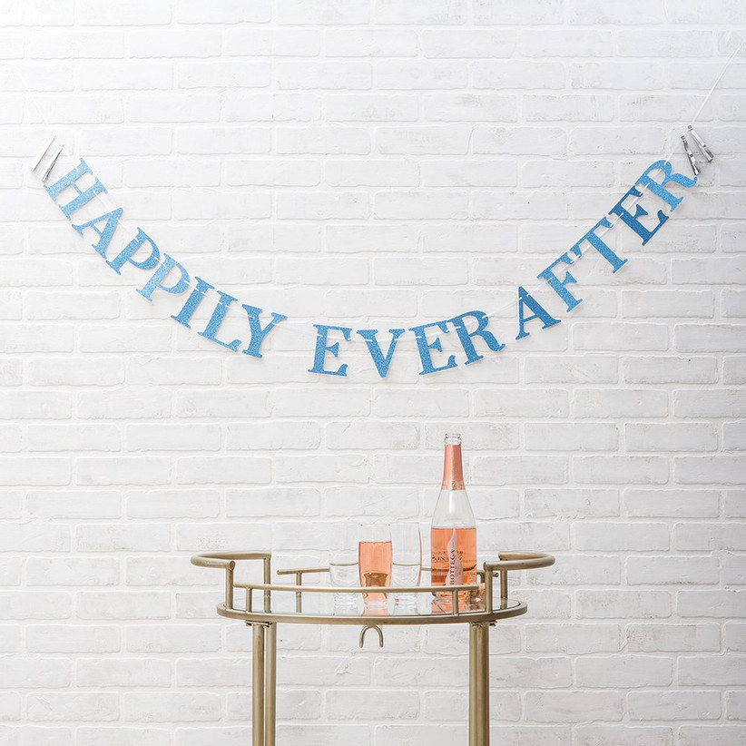 Glittery blue Happily Ever After banner over cocktail table