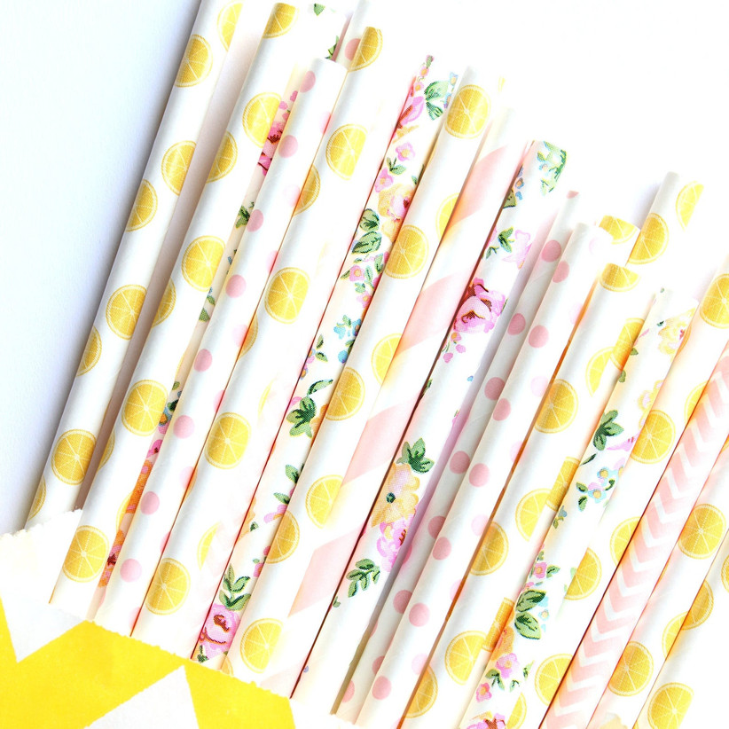 Close up of summer themed drinking straws with lemon, floral, polka-dot, and striped patterns