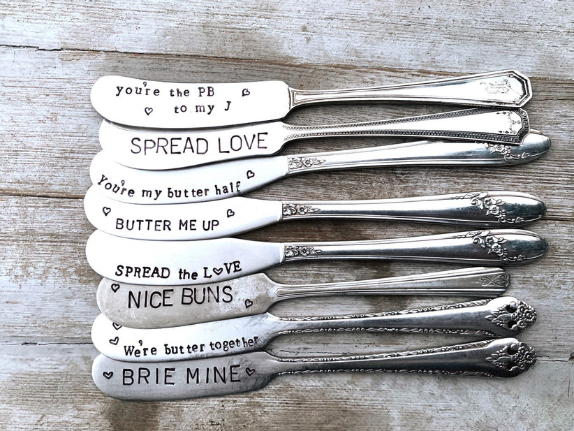 Array of metal spreading knives with cute engravings like Spread the Love