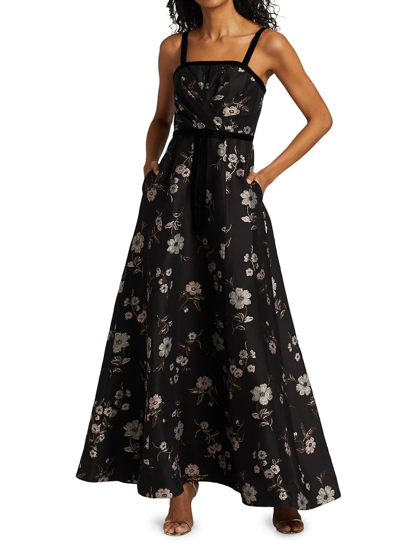 Model wearing black velvet strap floral maxi dress with metallic florals and pockets