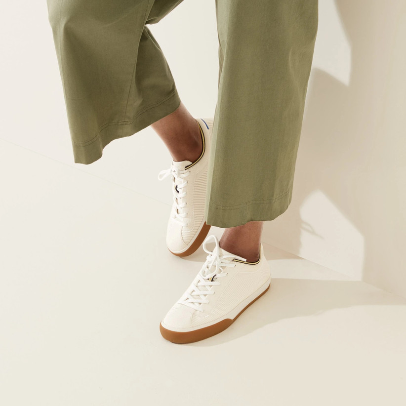 White lace-up sneakers with sandy-colored sole 