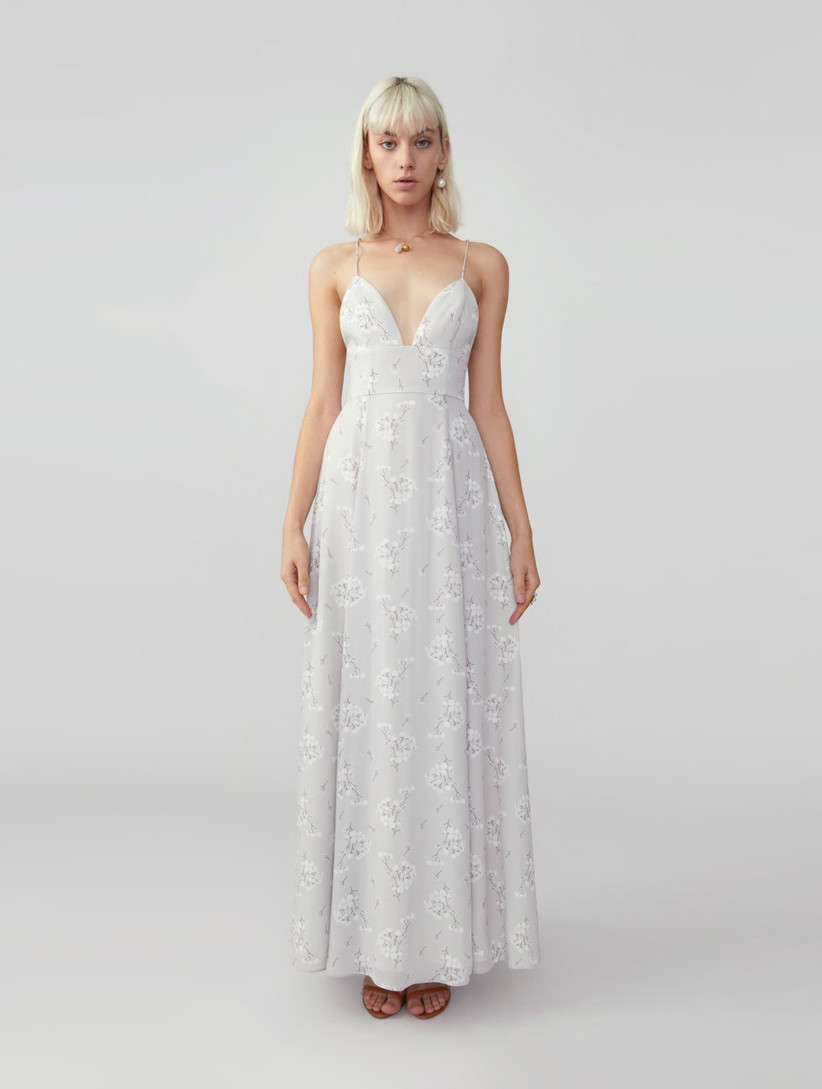 Model wearing minimalist gray spaghetti strap maxi dress with subtle white florals