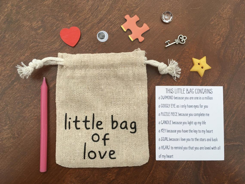 Burlap little bag of love with assorted contents displayed around it and an explanatory key