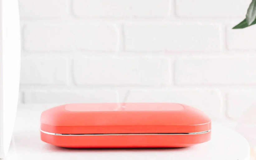 Red PhoneSoap Pro closed on the countertop 