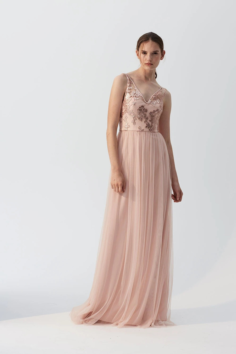 Model wearing blush pink tulle bridesmaid dress with sequined bodice