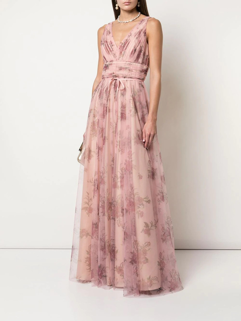 Model wearing sleeveless V-neck floral bridesmaid dress with pink tulle skirt