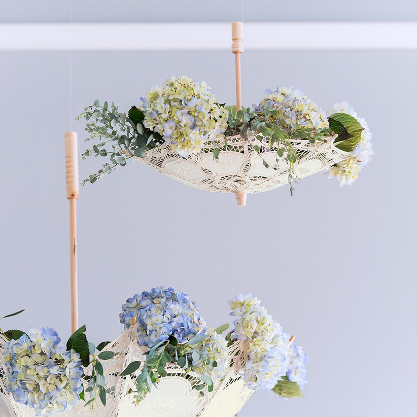 Elegant upside down white lace parasols filled with pretty flowers 