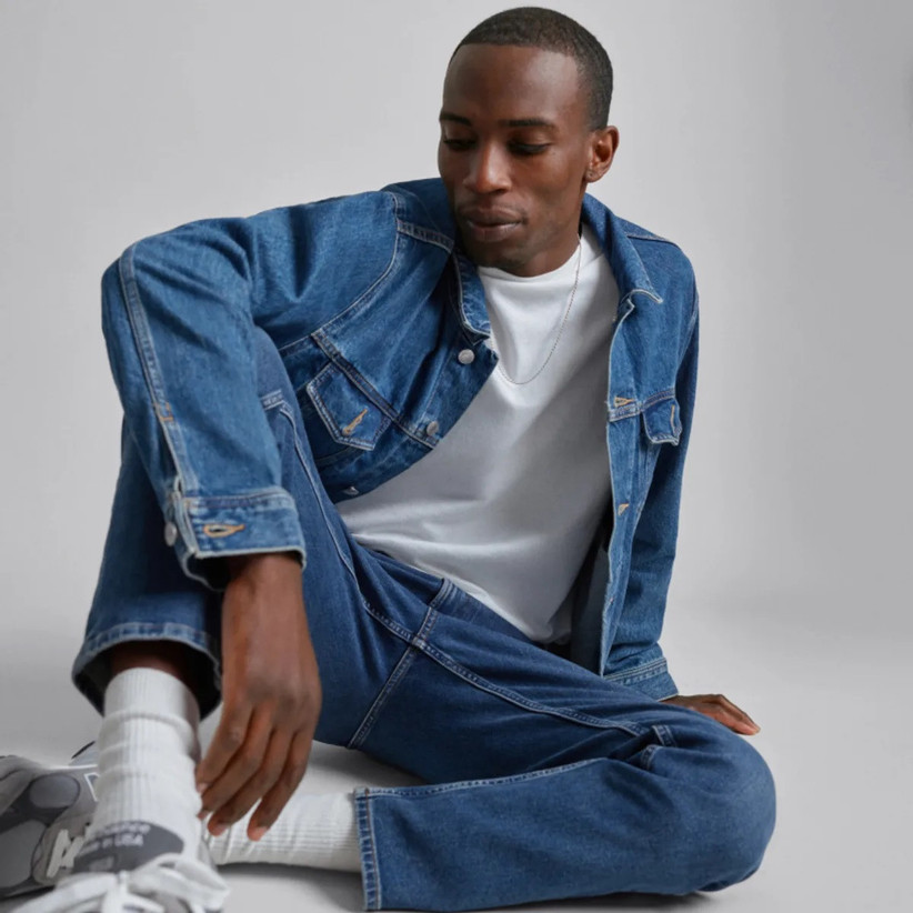 Model wearing trendy blue jean jacket with a white tee and blue jeans