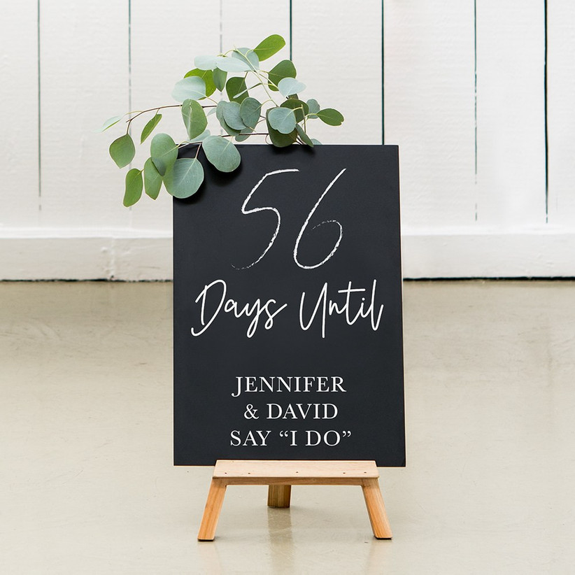 Rustic chalkboard on wooden easel that reads 56 Days Until Jennifer & David Say I Do