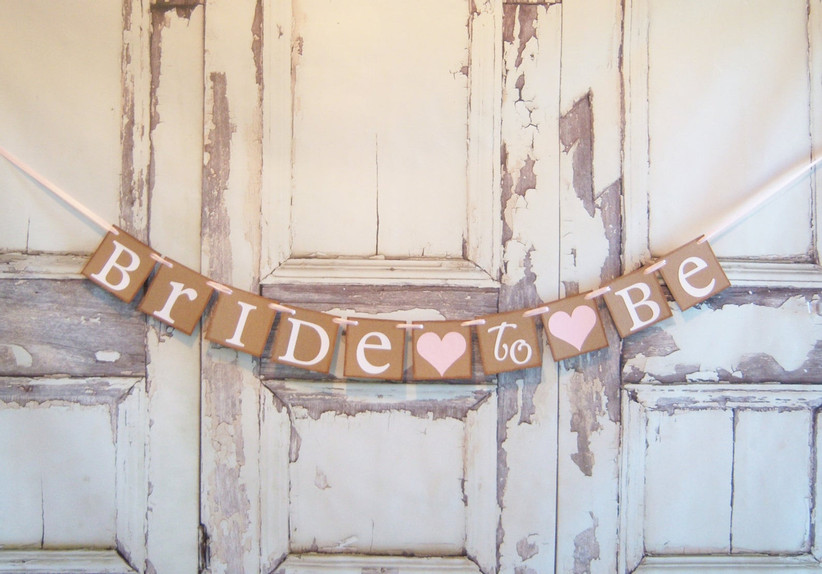 Cardstock Bride to Be banner against a rustic whitewashed backdrop