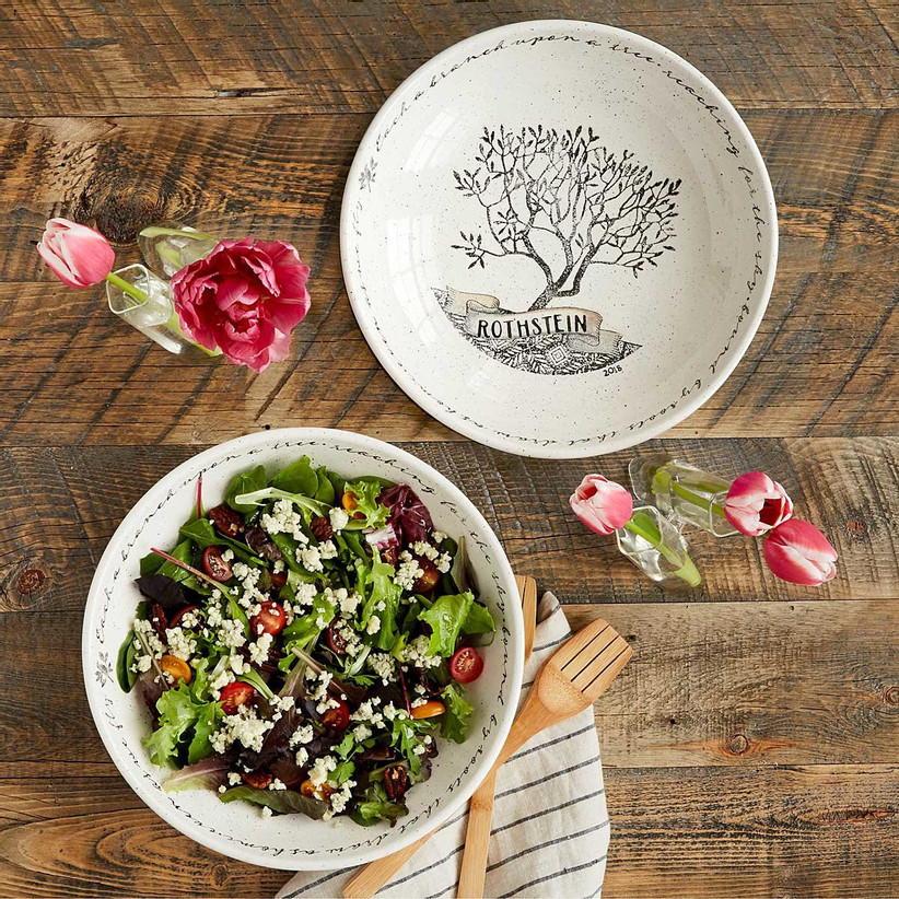 White and black personalized family tree bowl shown empty as well as full of salad