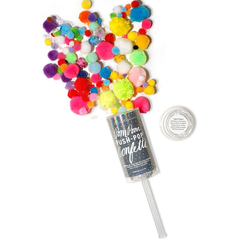 Push-pop confetti popper spilling open to show colorful pom pom confetti on white background