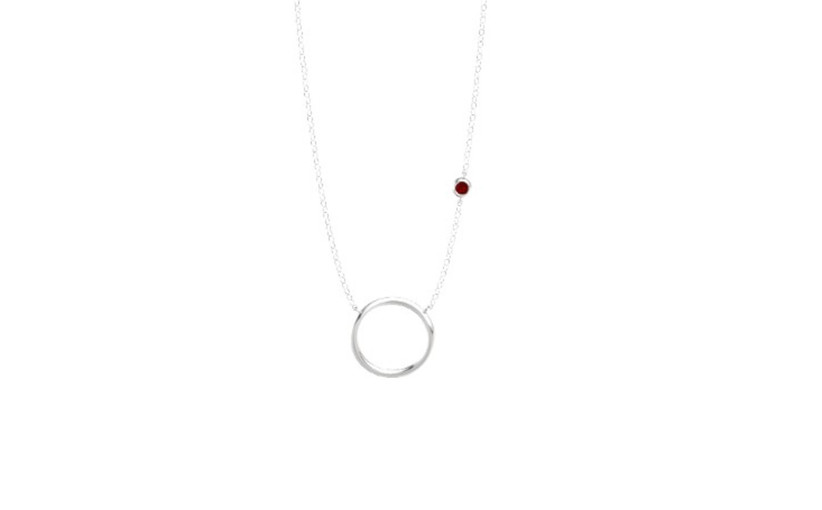 silver circle pendant with small ruby on one side