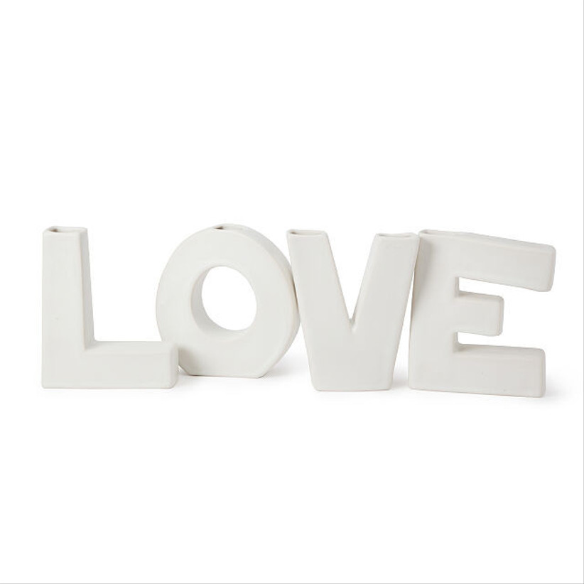 white vase in the shape of the word love