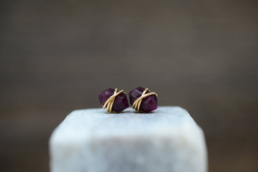 raw ruby diamond shaped stud earrings wrapped in gold