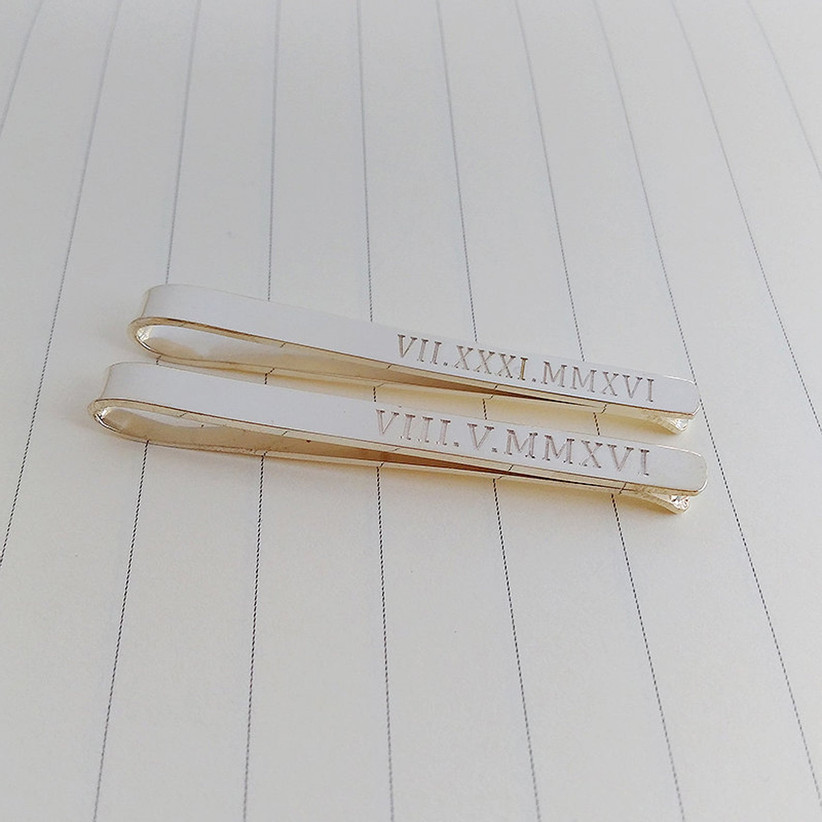 silver tie clip engraved with roman numerals