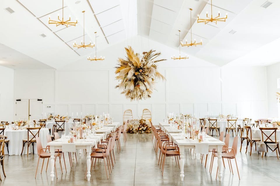 How To Choose A Wedding Venue | An industrial all-white event space with pampas grass chandelier at The Hutton House