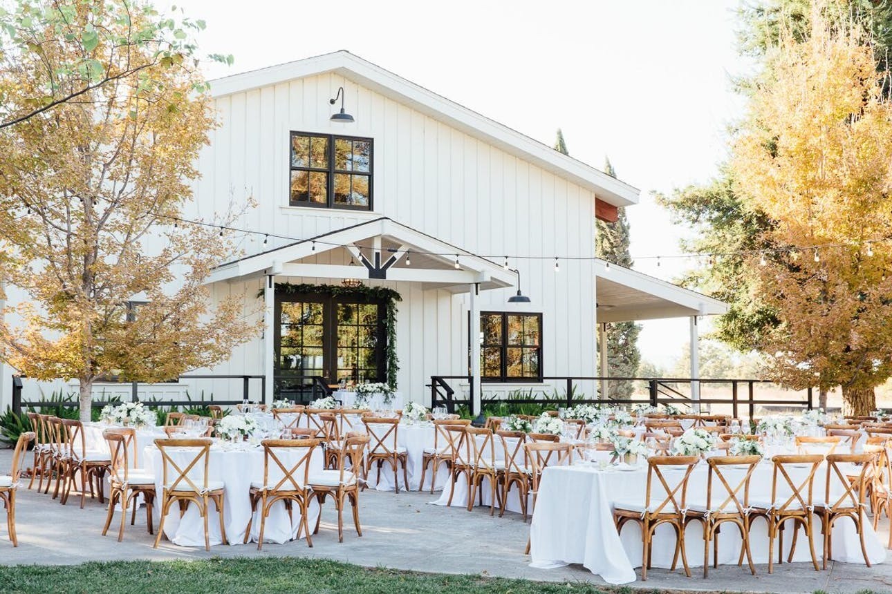 A cozy wedding reception in front of Park Winters, a beautiful white barn in Winters, CA