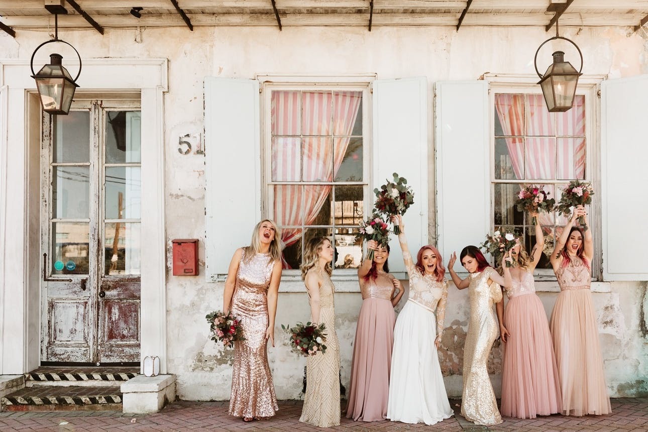 Choosing the right wedding venue | Bridesmaids pose in front of Race + Religious in New Orleans, LA