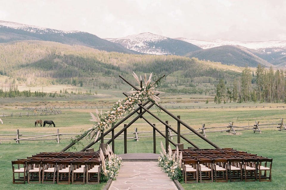 A serene and rustic outdoor ceremony with mountain views at Devil's Thumb Ranch Resort and Spa